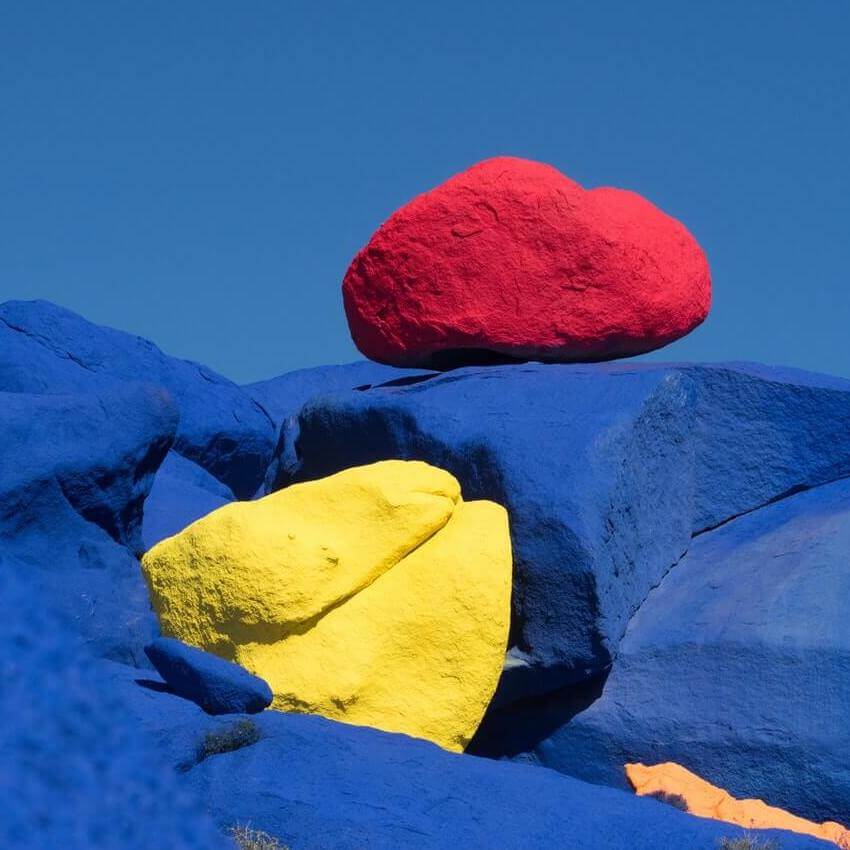 different sized rocks painted in several colours